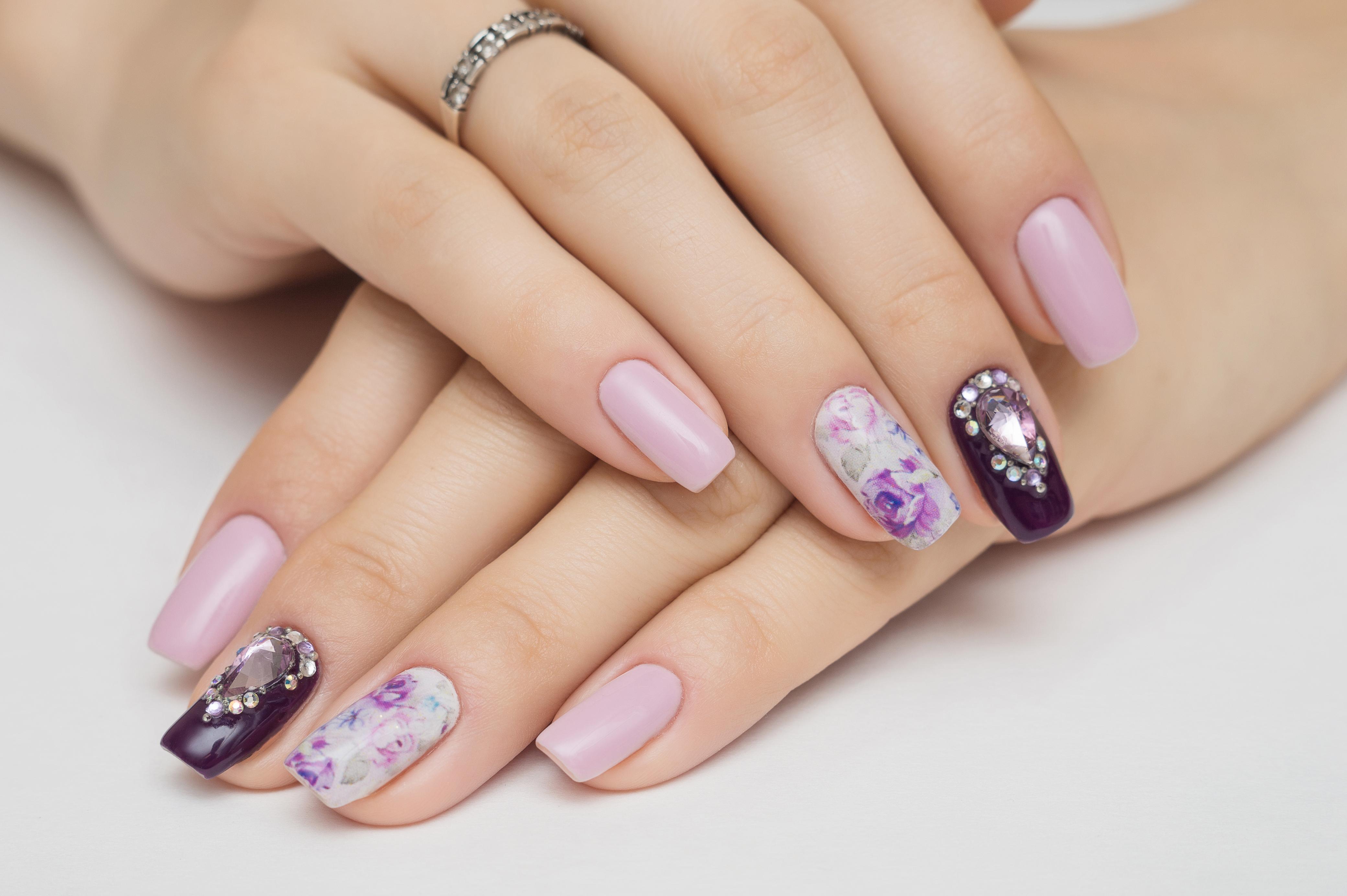 Pink nails decorated with crystal accents